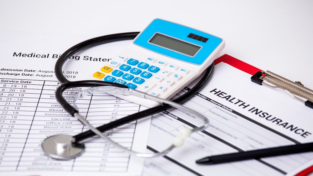 Health care costs. Stethoscope and calculator symbol for health care costs or medical insurance.
