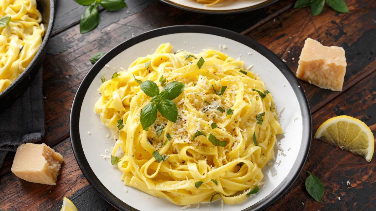 Pasta al Limone, Lemon with basil and parmesan cheese on wooden table.