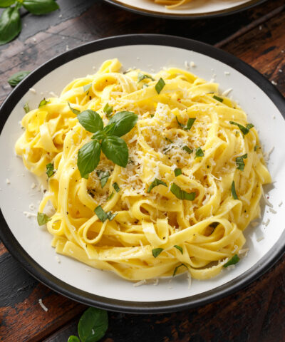 Pasta al Limone, Lemon with basil and parmesan cheese on wooden table.