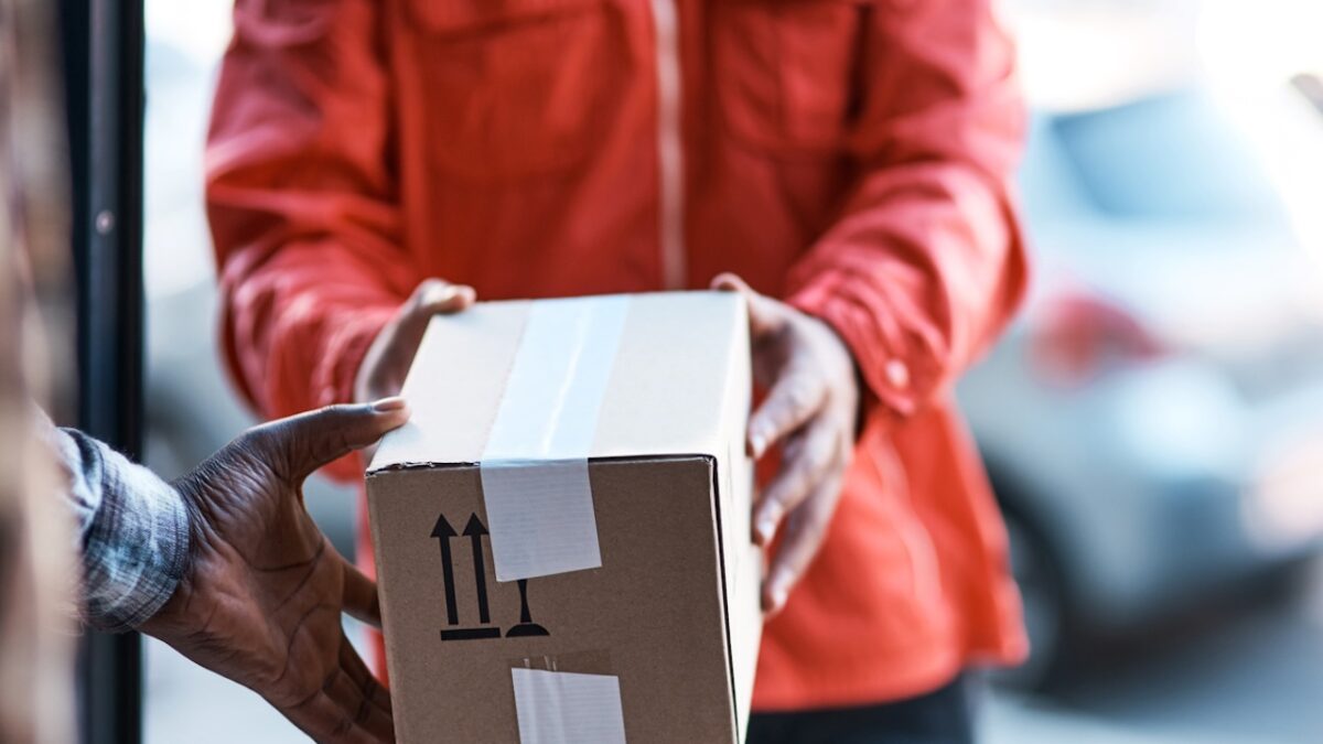 Cropped shot of a delivery man handing over a package