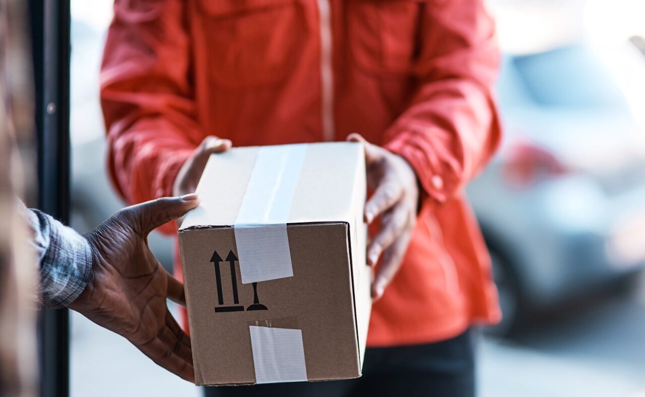 Cropped shot of a delivery man handing over a package