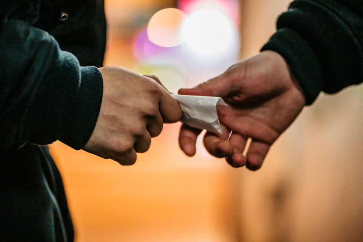 Addict young man have meeting with dealer at night to buy dose of white powder cocaine.