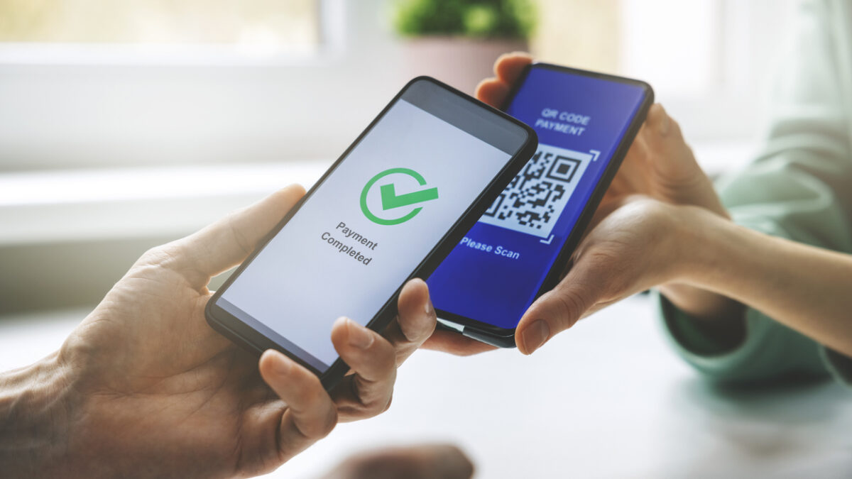 qr code payment - person paying with mobile phone