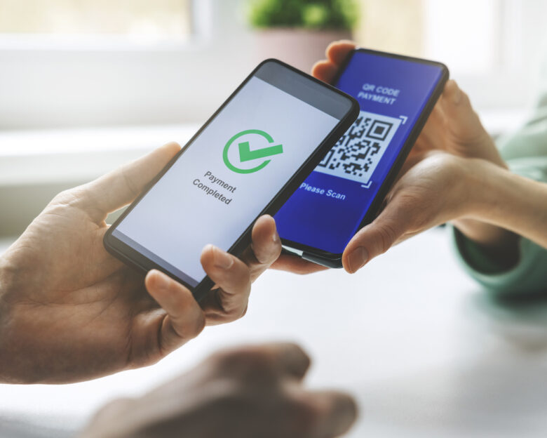 qr code payment - person paying with mobile phone