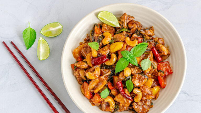 Thai Stir-Fried Chickenwith Chopsticks Directly Above Photo on White Background