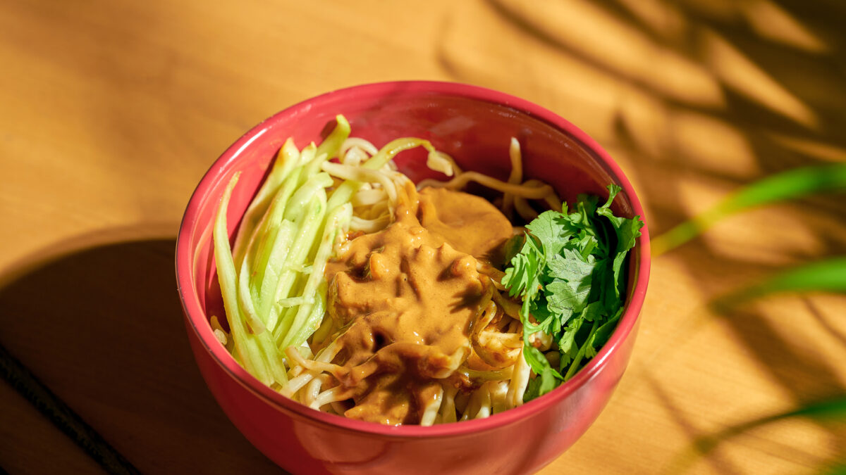 Vegetarian Chinese noodles with vegetables and sesame paste in a bowl. Chinese cuisine