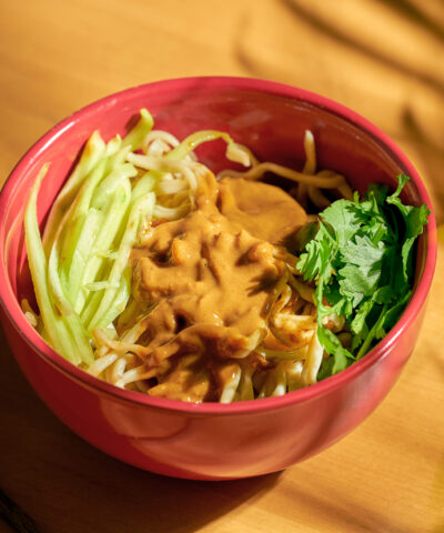 Vegetarian Chinese noodles with vegetables and sesame paste in a bowl. Chinese cuisine