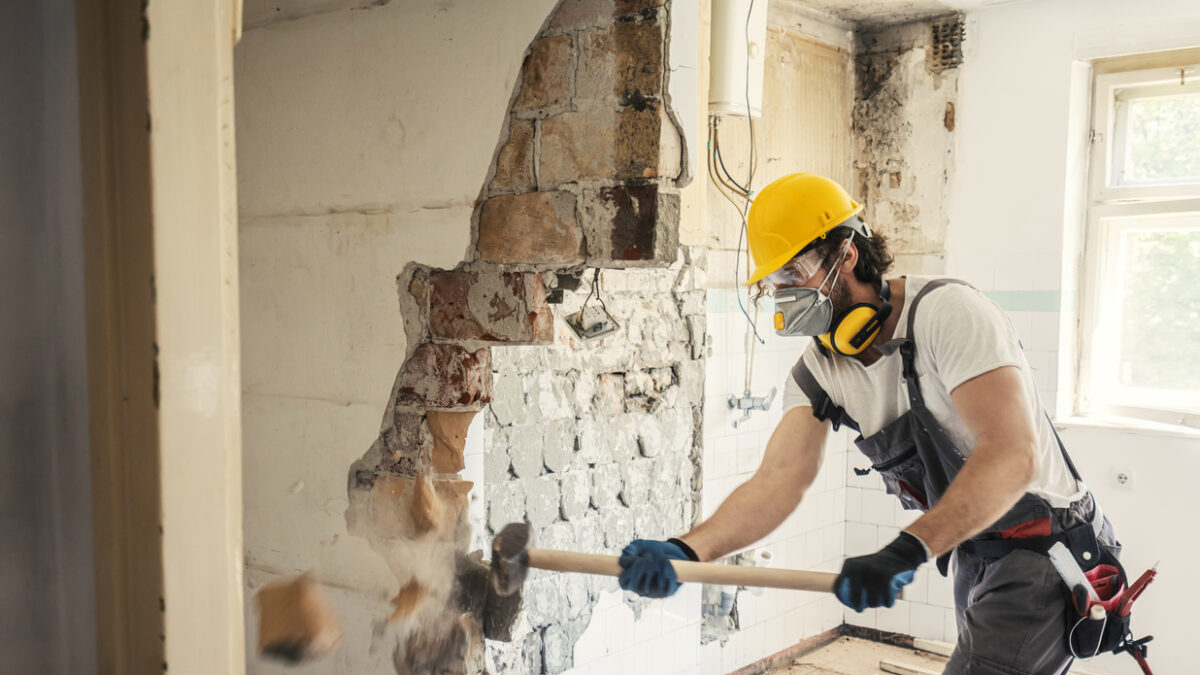 Worker using hammer, home renovation