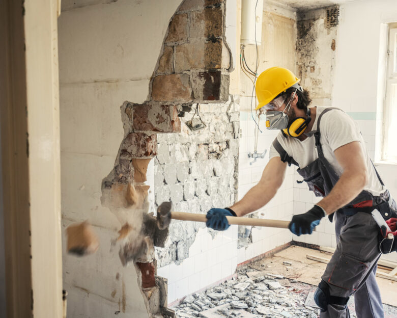 Worker using hammer, home renovation