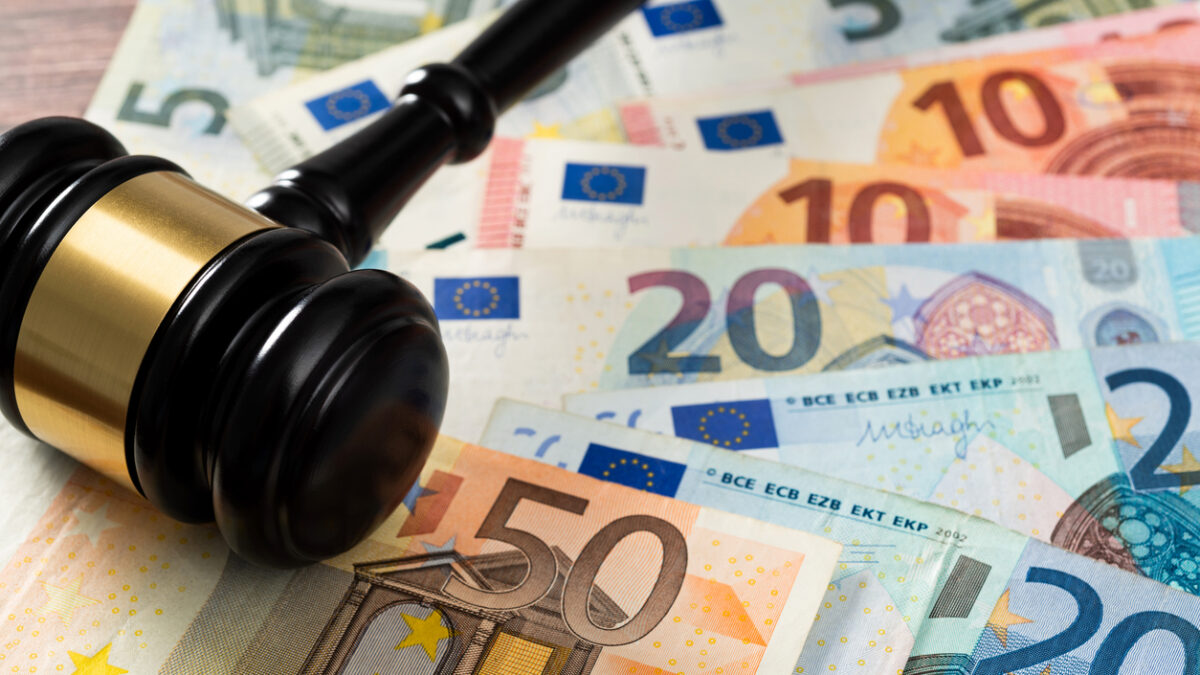 Gavel and stack European Union currency on the table.