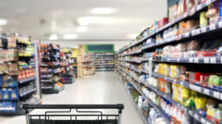 choosing a dairy products at supermarket.empty grocery cart in an empty supermarket