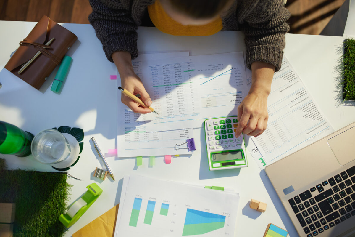 accountant woman with calculator and documents working in office