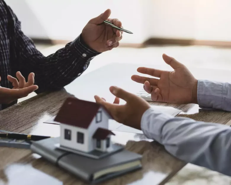 Real estate agents discuss home and land purchases with customers after agreeing to a home purchase and loan agreement.