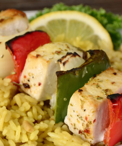 "A grilled shish kebab made of fresh swordfish, bell peppers and onions served over rice pilaf."