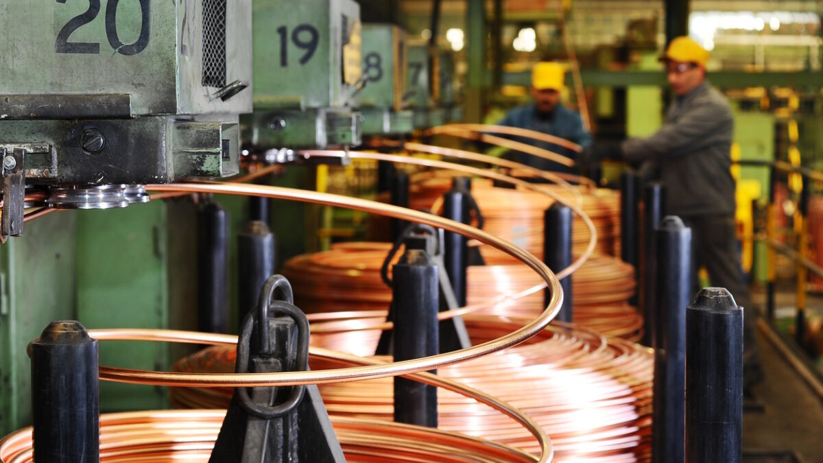 Heavy machinery in copper factory. Blurred workers