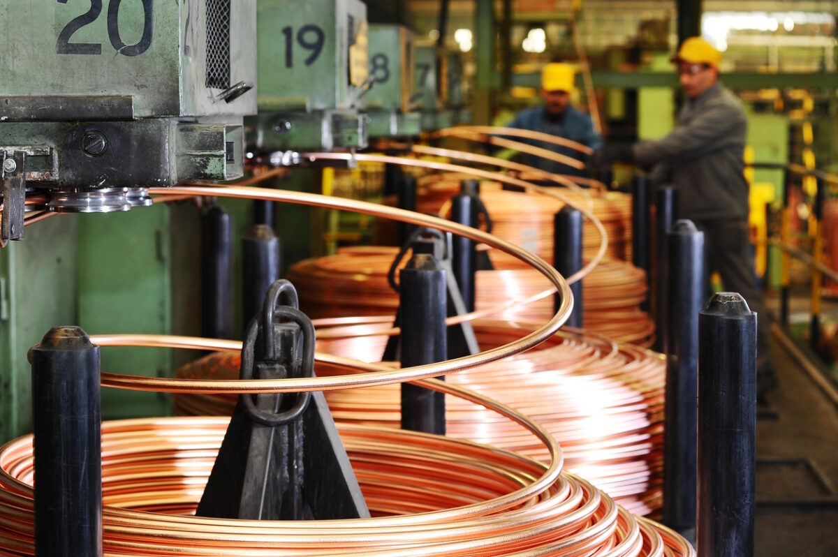 Heavy machinery in copper factory. Blurred workers