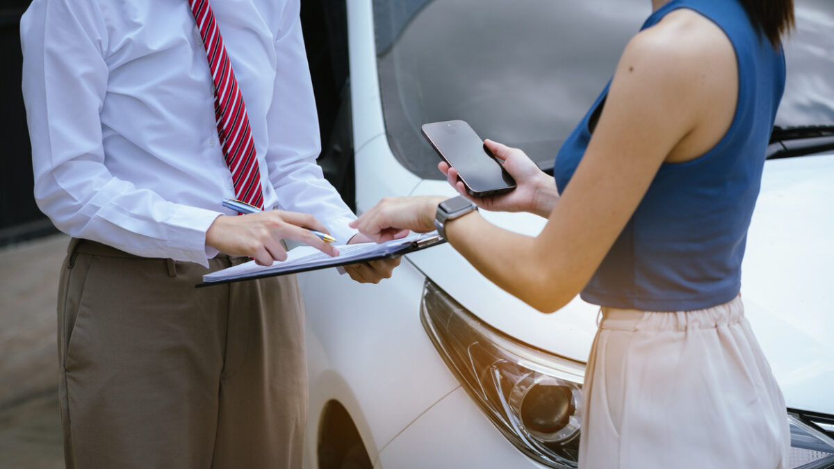 Insurance concept, insurance agent checking broken car and submit a claim form after an accident traffic accident