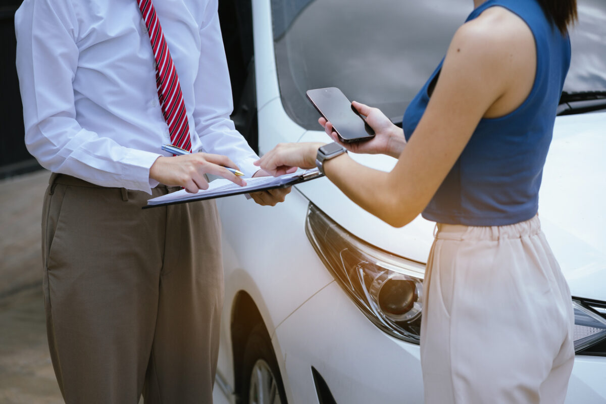 Insurance concept, insurance agent checking broken car and submit a claim form after an accident traffic accident