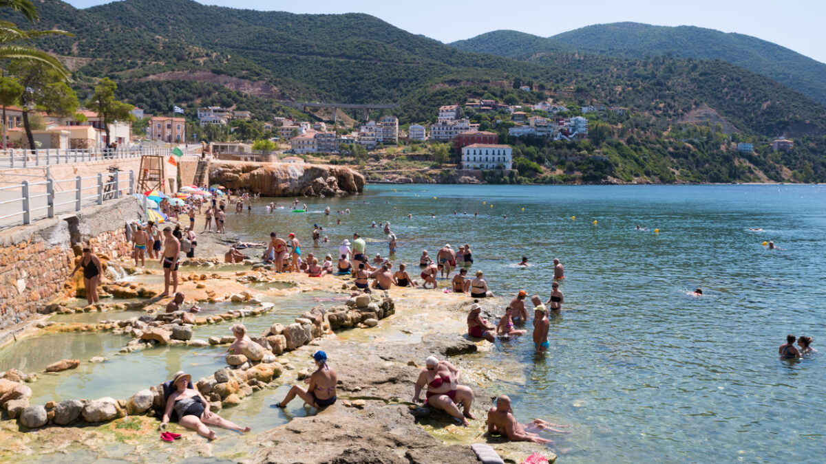 The waterfront of Aidipsos, a Greek town in North Evia famous for its hot springs and spas, with lots of people enjoying the free warm water spa
