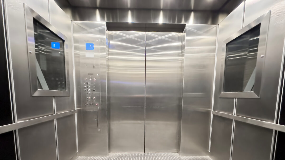 Inside view of an empty steel industrial elevator of an office