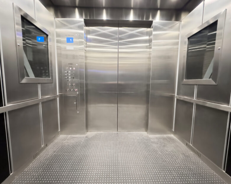 Inside view of an empty steel industrial elevator of an office