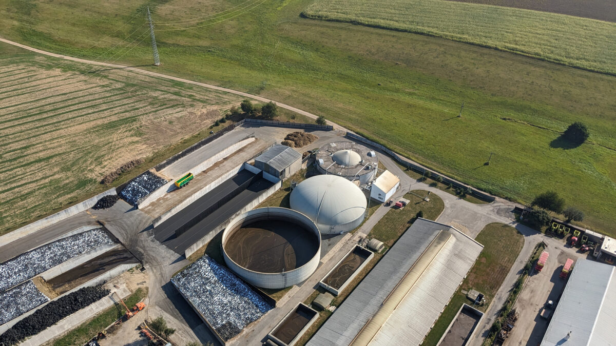 Aerial panorama landscape of biogas power plant and surrounding agricultural landscape showing biogas production, bioenergy generation, and green renewable electricity during the European energy crisis