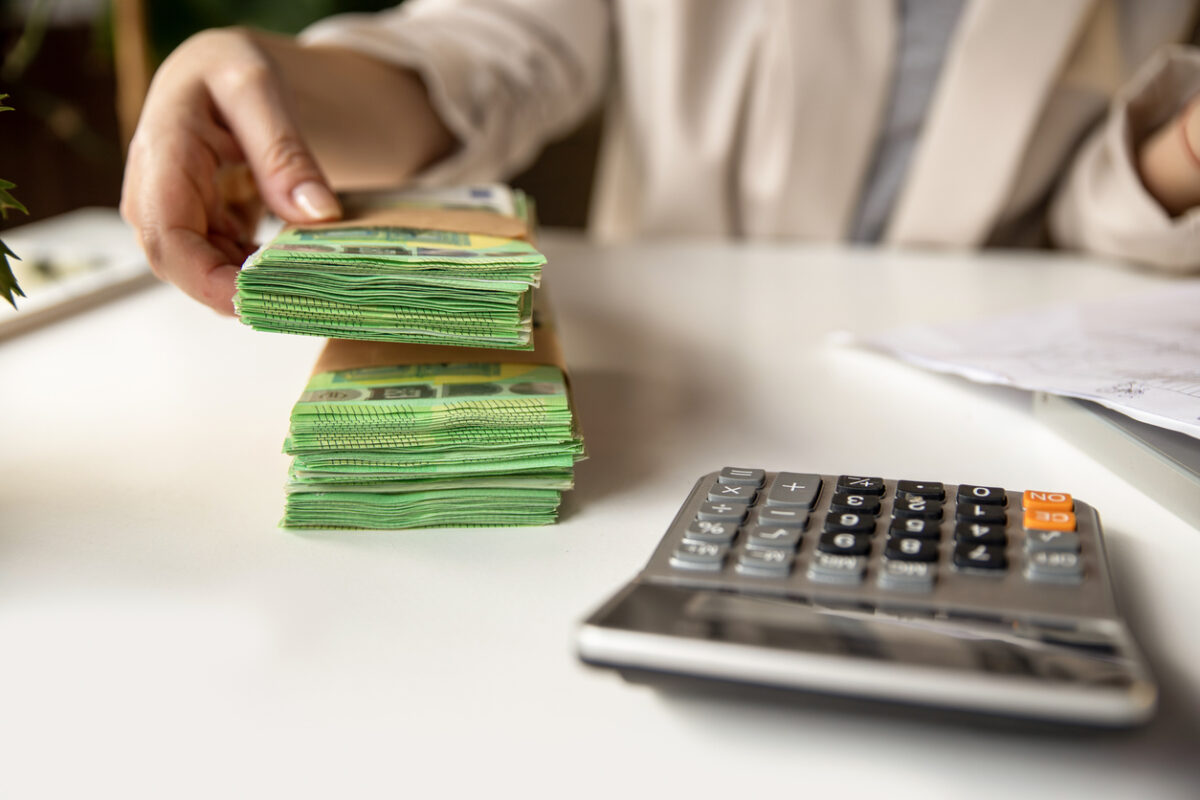 Unrecognizable Female account manager with euros, home budget documents, laptop and calculator in office or home workspace