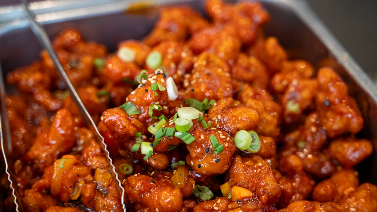 Close up of spicy glazed fried chicken in buffet tray.