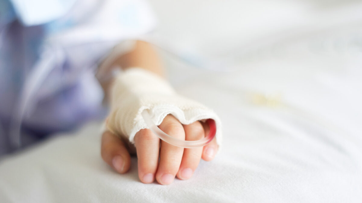 Saline intravenous (iv) drip in a Children's patient hand