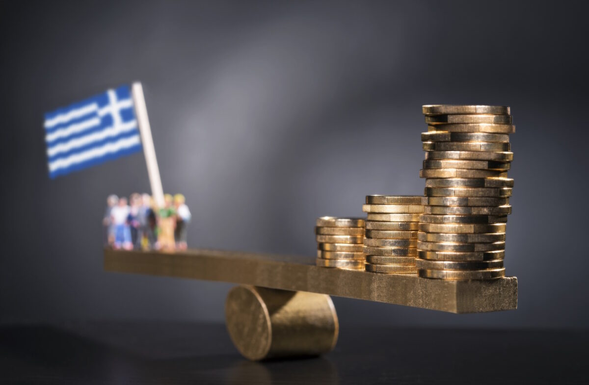 Seesaw with coins on one side and a group of people with Greek flag.