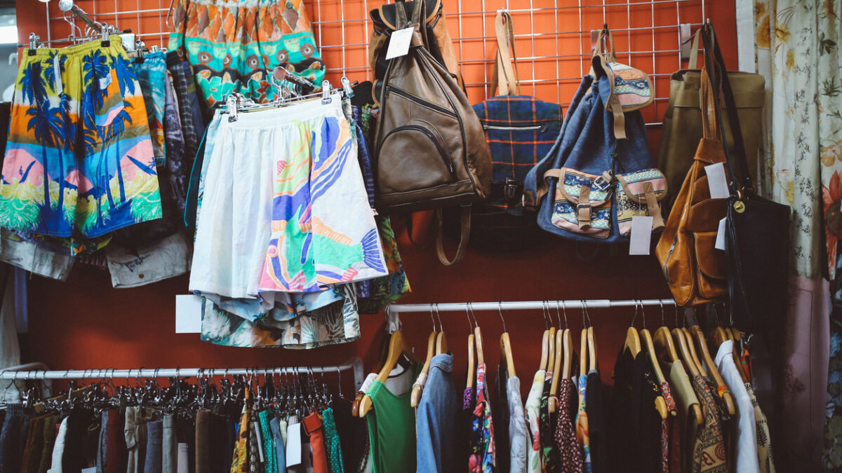 Vintage toned image of a second hand store somewhere in East London. Lots of different styles of clothing, colorful shirts and other used items for a bargain price.