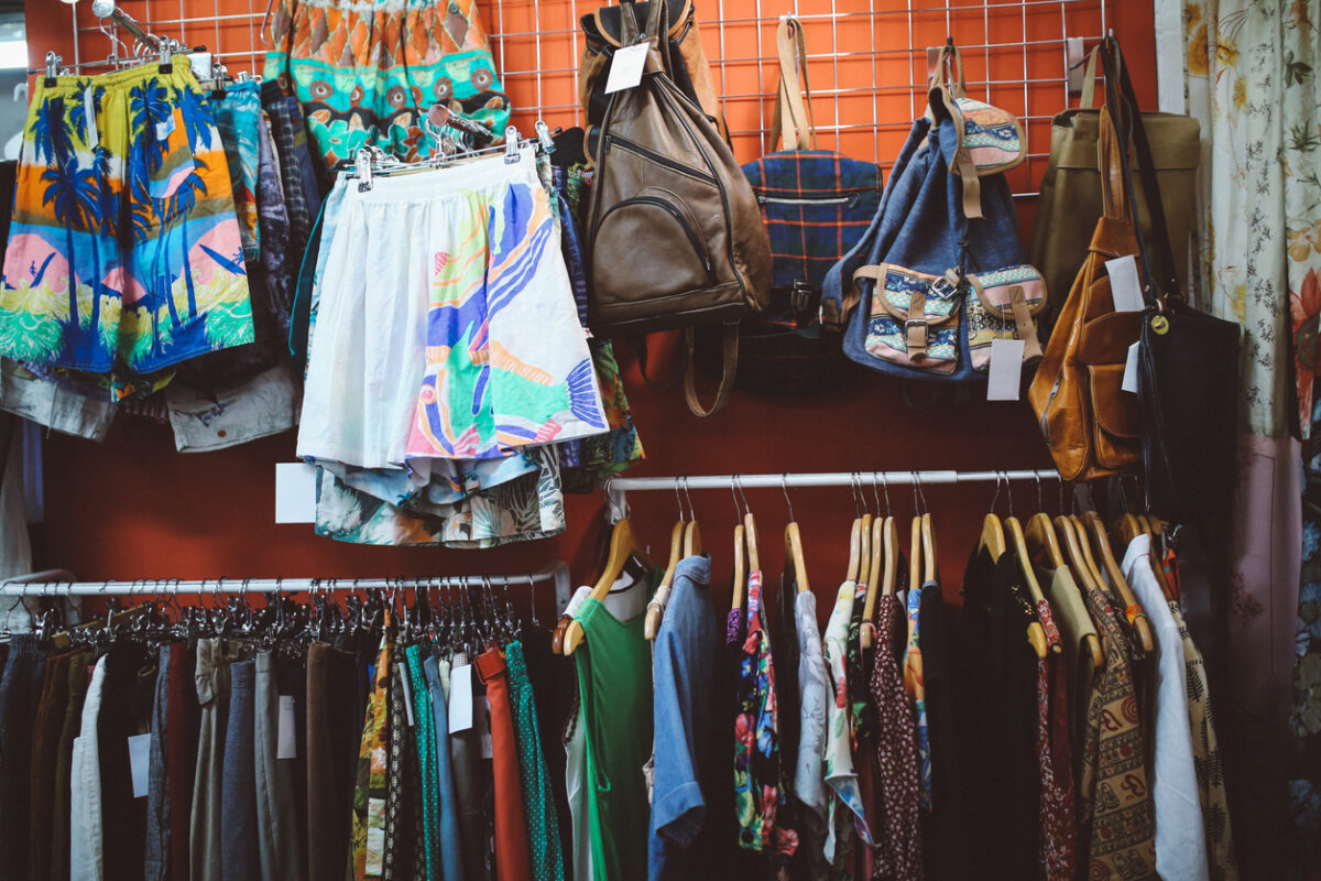 Vintage toned image of a second hand store somewhere in East London. Lots of different styles of clothing, colorful shirts and other used items for a bargain price.