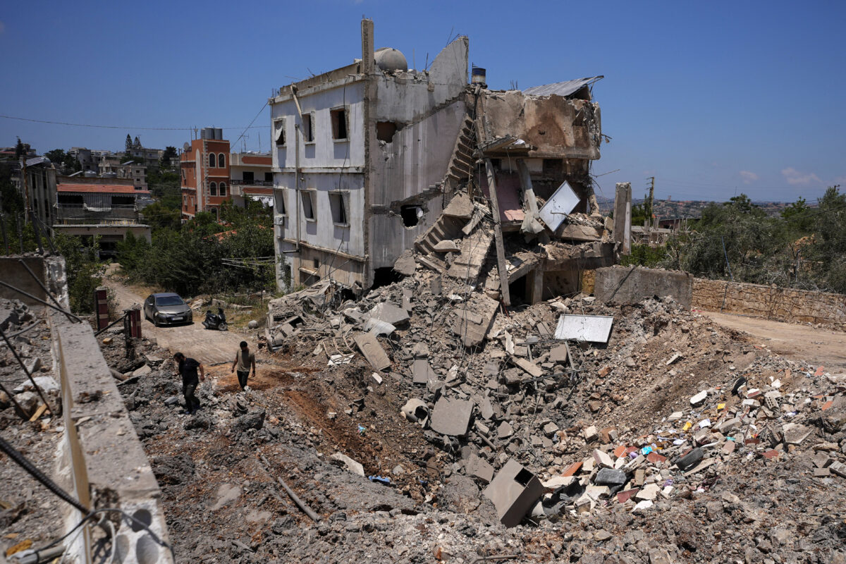 People inspect the site of a previous Israeli strike in Kfar Sir in the Nabatieh district, Lebanon June 16, 2026, following a deal between the United States and Iran. REUTERS/Stringer