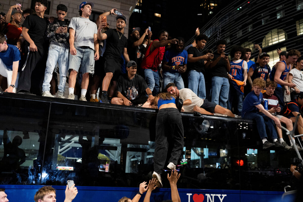 Fans celebrate the New York Knicks' win against the San Antonio Spurs in Game 5 of the NBA Finals, on a street near Madison Square Garden, in New York City, U.S., June 14, 2026.  REUTERS