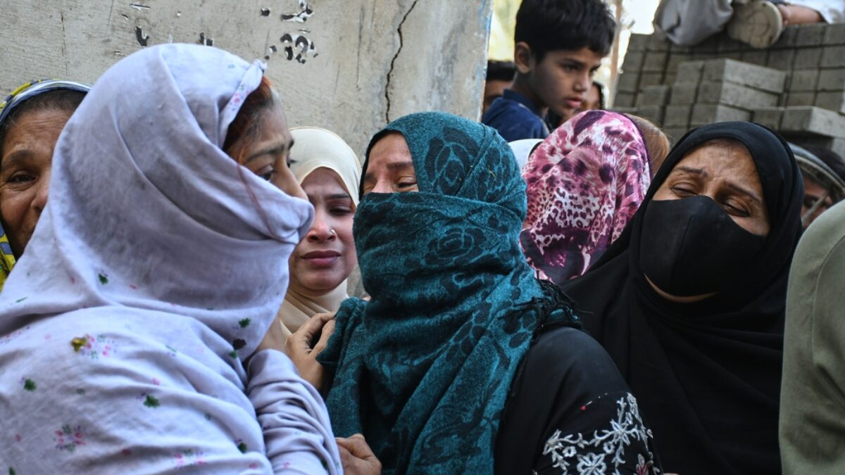 Women mourn over the death of their relatives near the site of a gas explosion in an apartment building, in Karachi, Pakistan, Thursday, Feb. 19, 2026.