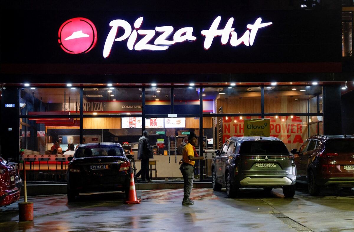 FILE PHOTO: A security guard stands in front of a Pizza Hut fast food restaurant in Abidjan, Ivory Coast October 5, 2024.