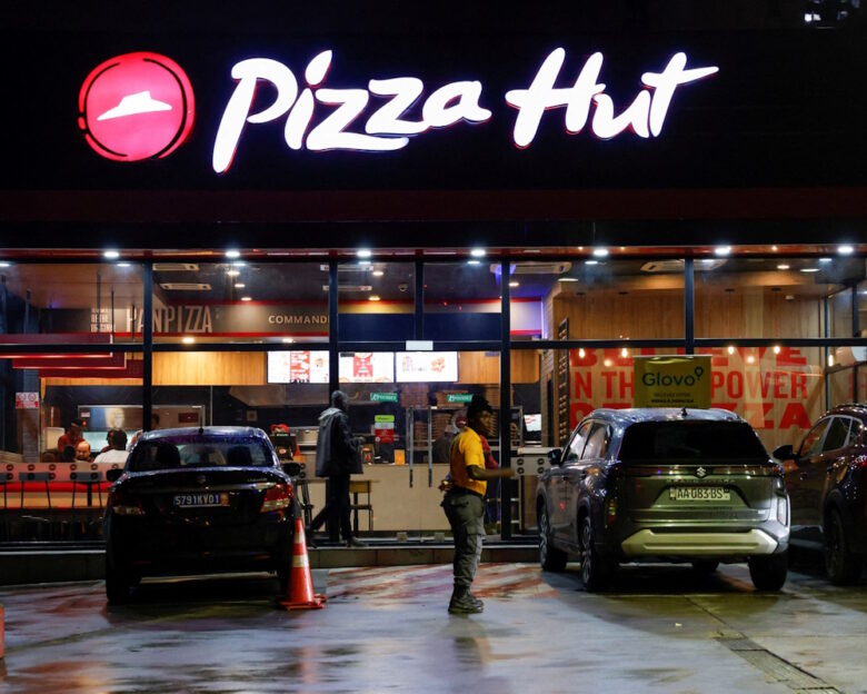 FILE PHOTO: A security guard stands in front of a Pizza Hut fast food restaurant in Abidjan, Ivory Coast October 5, 2024.