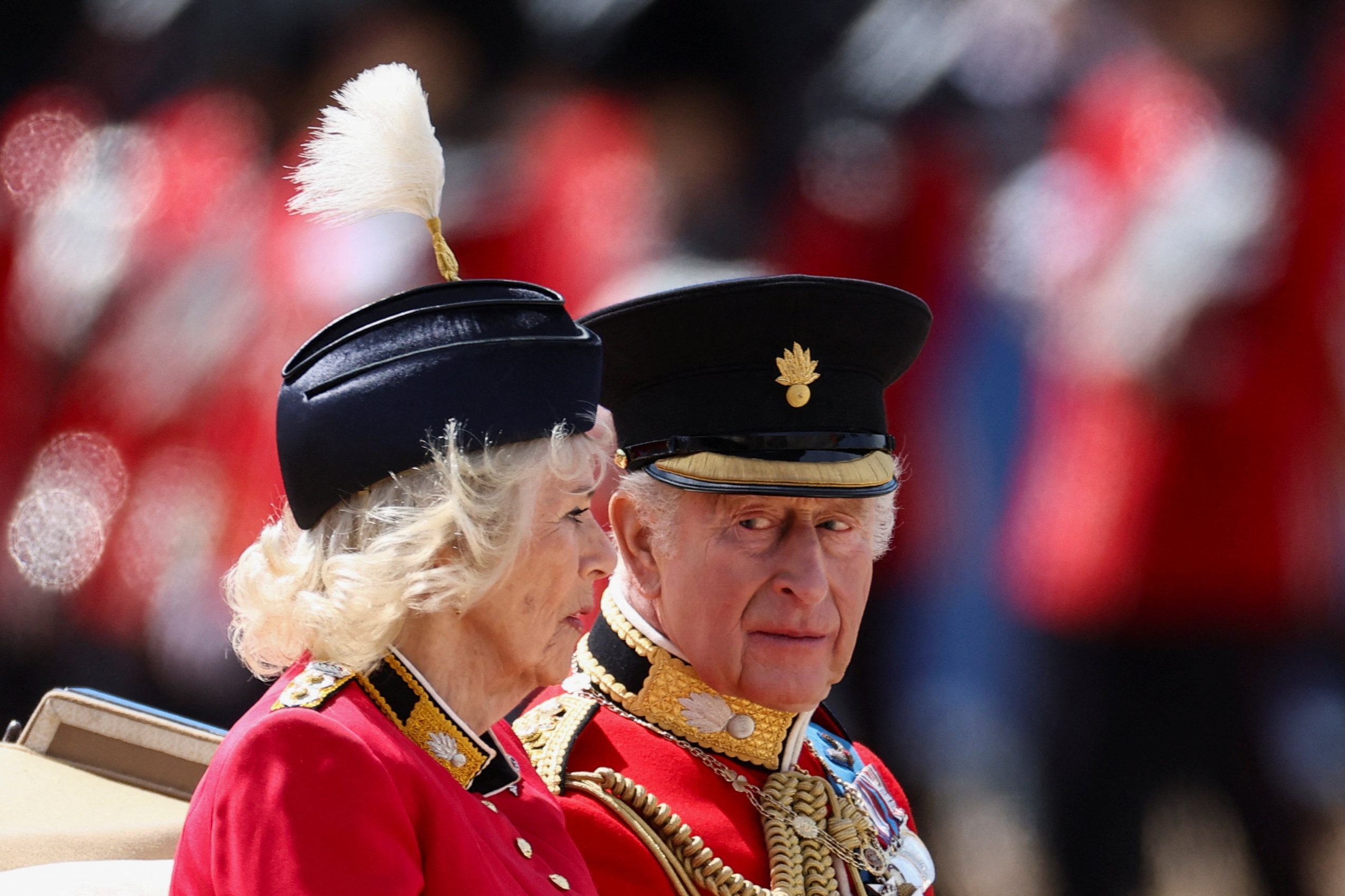 Britain's King Charles and Queen Camilla ride in a carriage during the Trooping the Colour parade to honour him, as part of the official birthday celebrations, in London, Britain, June 13, 2026. REUTERS