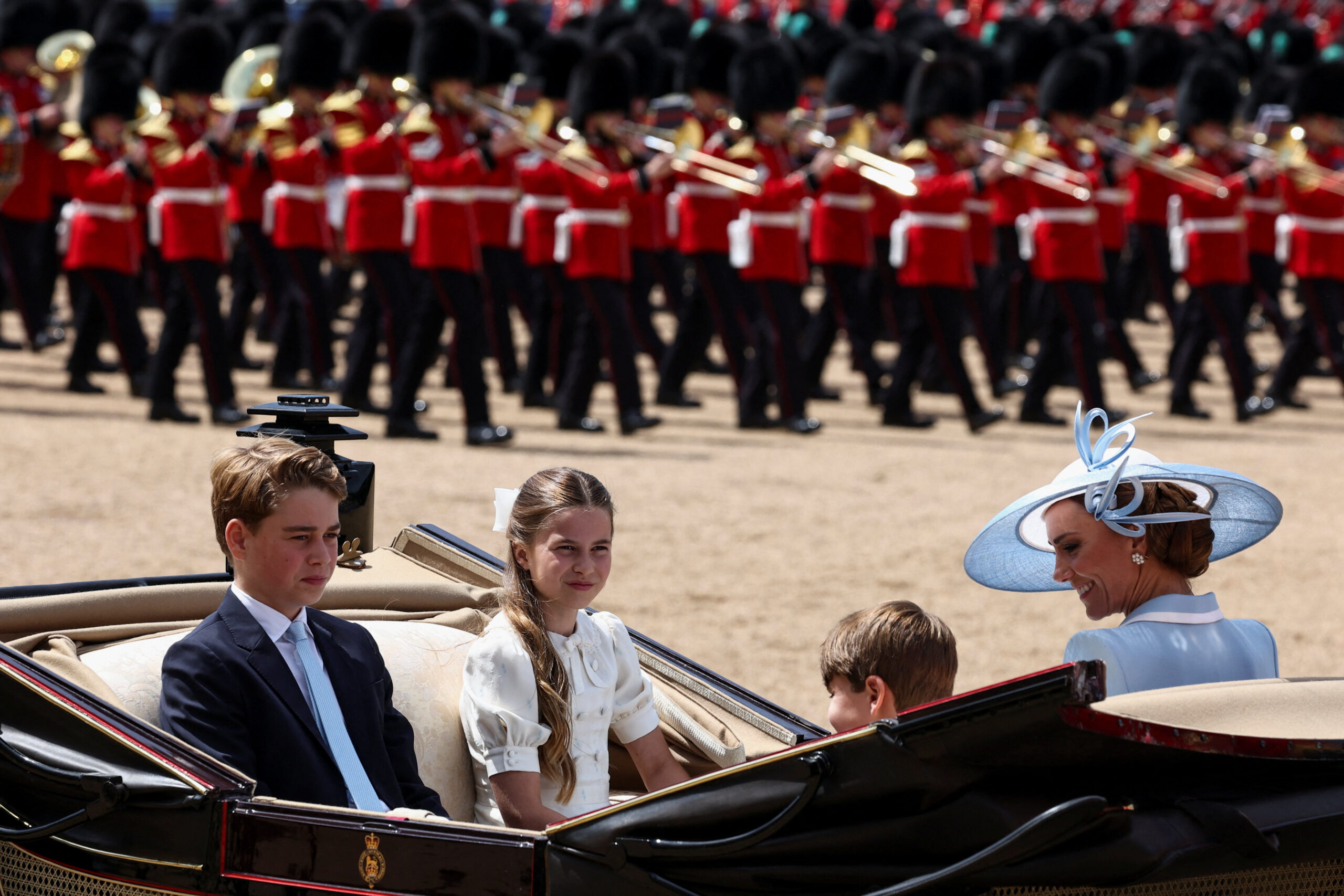 Britain's Kate, Princess of Wales, Prince George, Princess Charlotte, and Prince Louis ride in a carriage during the Trooping the Colour parade to honour Britain's King Charles, as part of the official birthday celebrations, in London, Britain, June 13, 2026. REUTERS