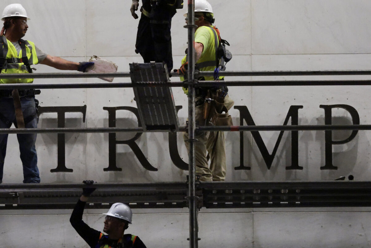 Workers prepare scaffolding ahead of removing lettering from the facade of the John F. Kennedy Memorial Center for the Performing Arts, following a federal judge’s order to remove U.S. President Donald Trump's name from the institution, in Washington, D.C., U.S., June 13, 2026. REUTERS/Jonathan Ernst