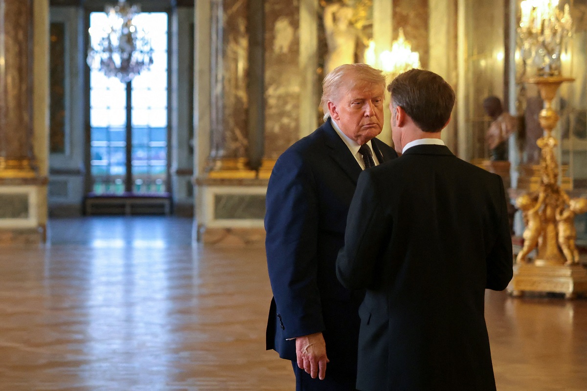 U.S. President Donald Trump speaks with President of France Emmanuel Macron as he receives a tour of Chateau de Versailles ahead of a dinner, France, June 17, 2026. Anna Moneymaker
