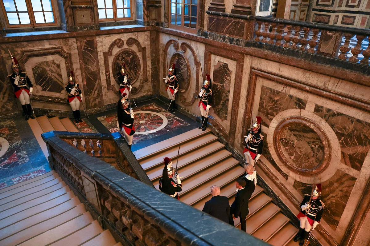 U.S. President Donald Trump and French President Emmanuel Macron arrive to Chateau de Versailles ahead of a dinner, France, June 17, 2026. Anna Moneymaker