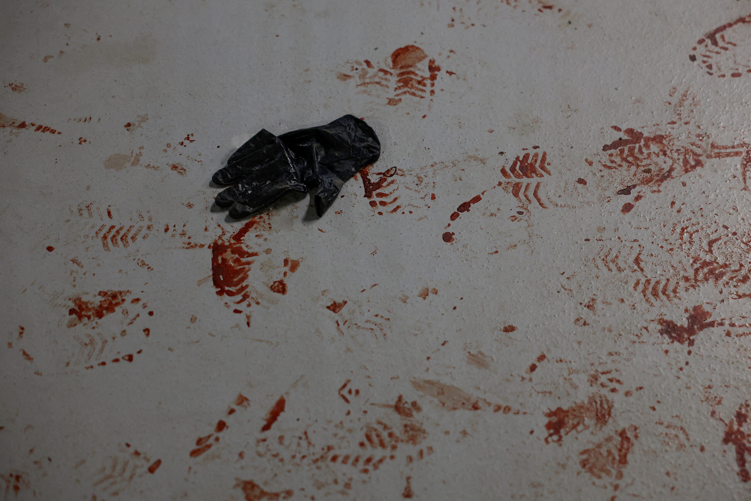 SENSITIVE MATERIAL. THIS IMAGE MAY OFFEND OR DISTURB A medical glove and blood stains inside an underground parking of an apartment building where injured residents tried to take shelter during Russian missile and drone strikes, amid Russia's attack on Ukraine, in Kyiv, Ukraine June 2, 2026. REUTERS/Valentyn Ogirenko TPX IMAGES OF THE DAY