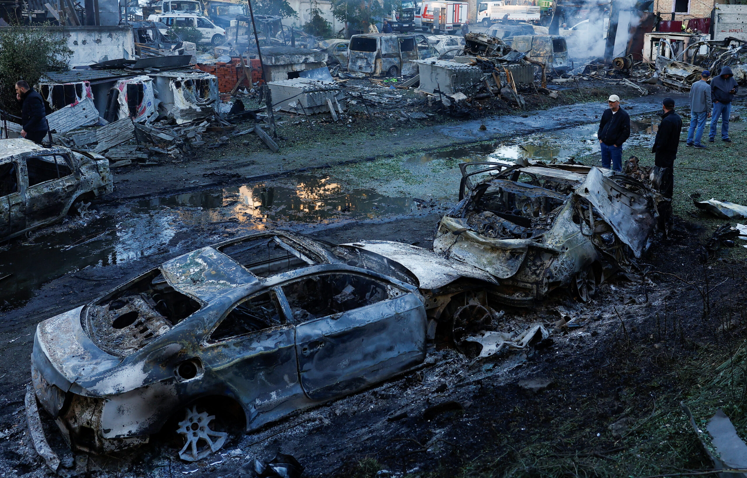 People look at cars damaged during Russian missile and drone strikes, at a garage, amid Russia's attack on Ukraine, in Kyiv, Ukraine June 2, 2026. REUTERS/Valentyn Ogirenko