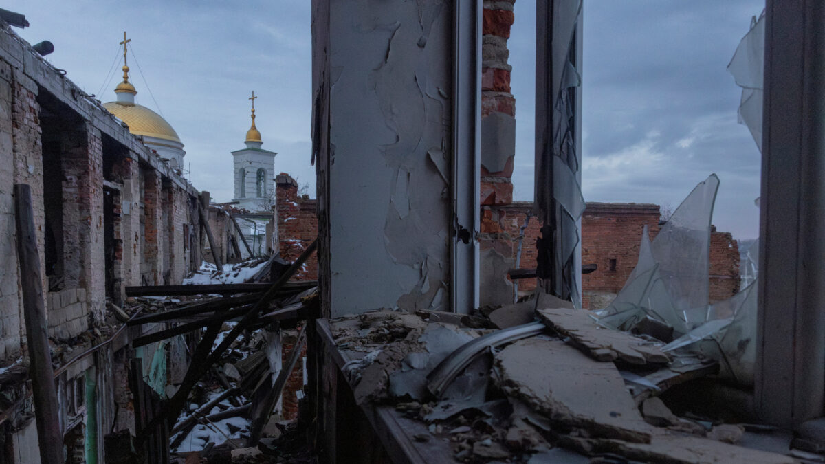 Church spires rise behind a school that was heavily damaged during fighting between occupying Russian forces and the Ukrainian army in Izium, Ukraine, January 29, 2026. REUTERS/Thomas Peter