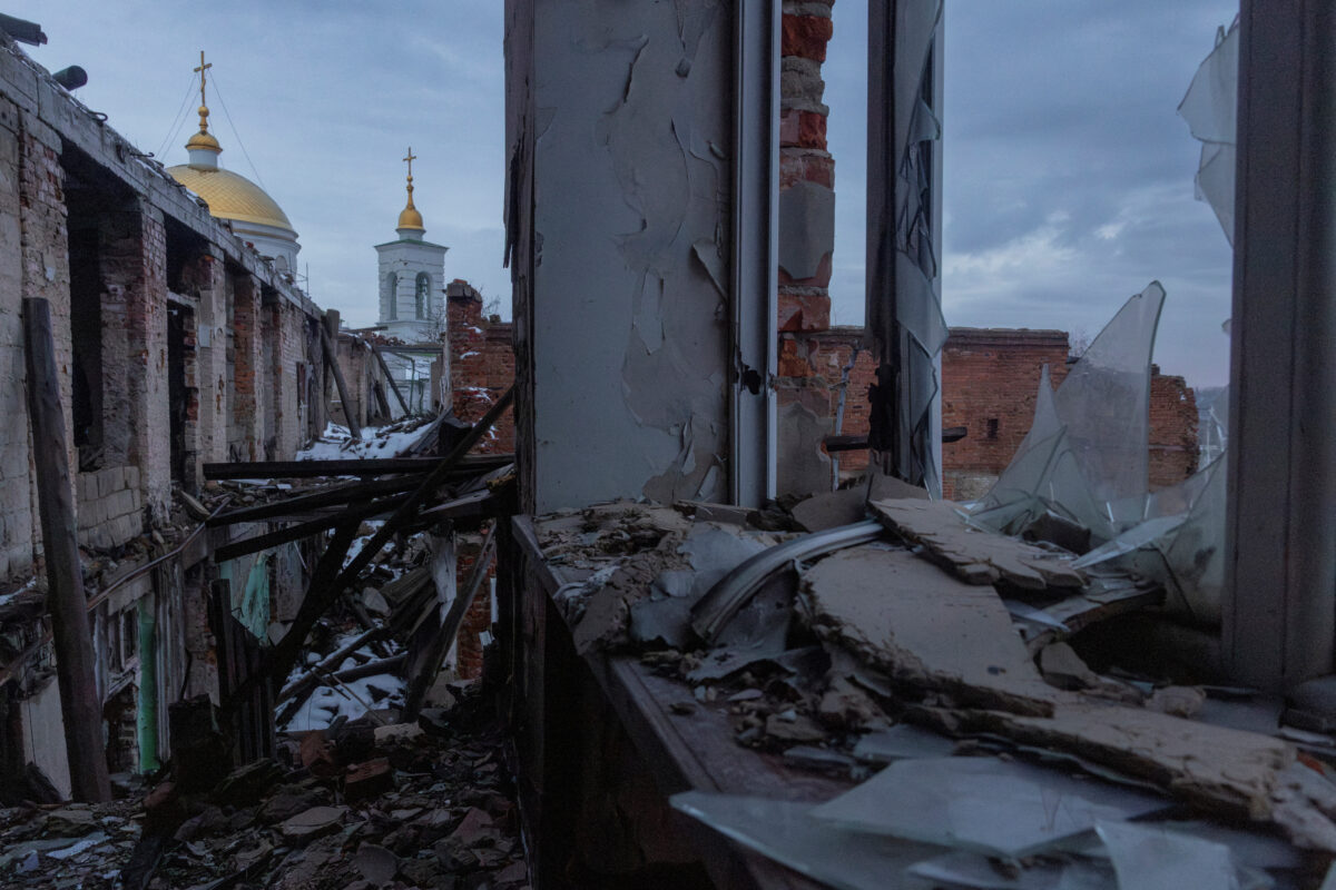 Church spires rise behind a school that was heavily damaged during fighting between occupying Russian forces and the Ukrainian army in Izium, Ukraine, January 29, 2026. REUTERS/Thomas Peter