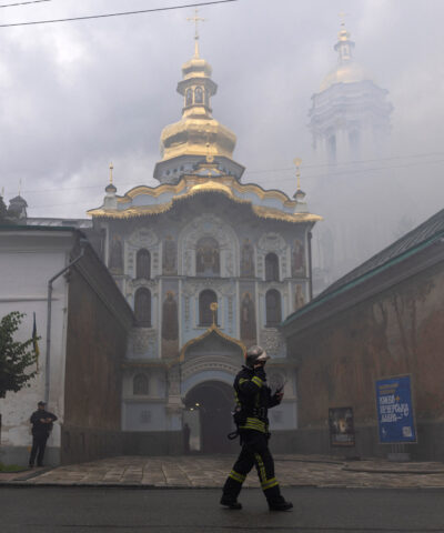 An emergency worker walks in front of Kyiv Pechersk Lavra, after it was hit during Russian missile and drone strikes, amid Russia's attack on Ukraine, in Kyiv, Ukraine June 15, 2026. REUTERS/Thomas Peter