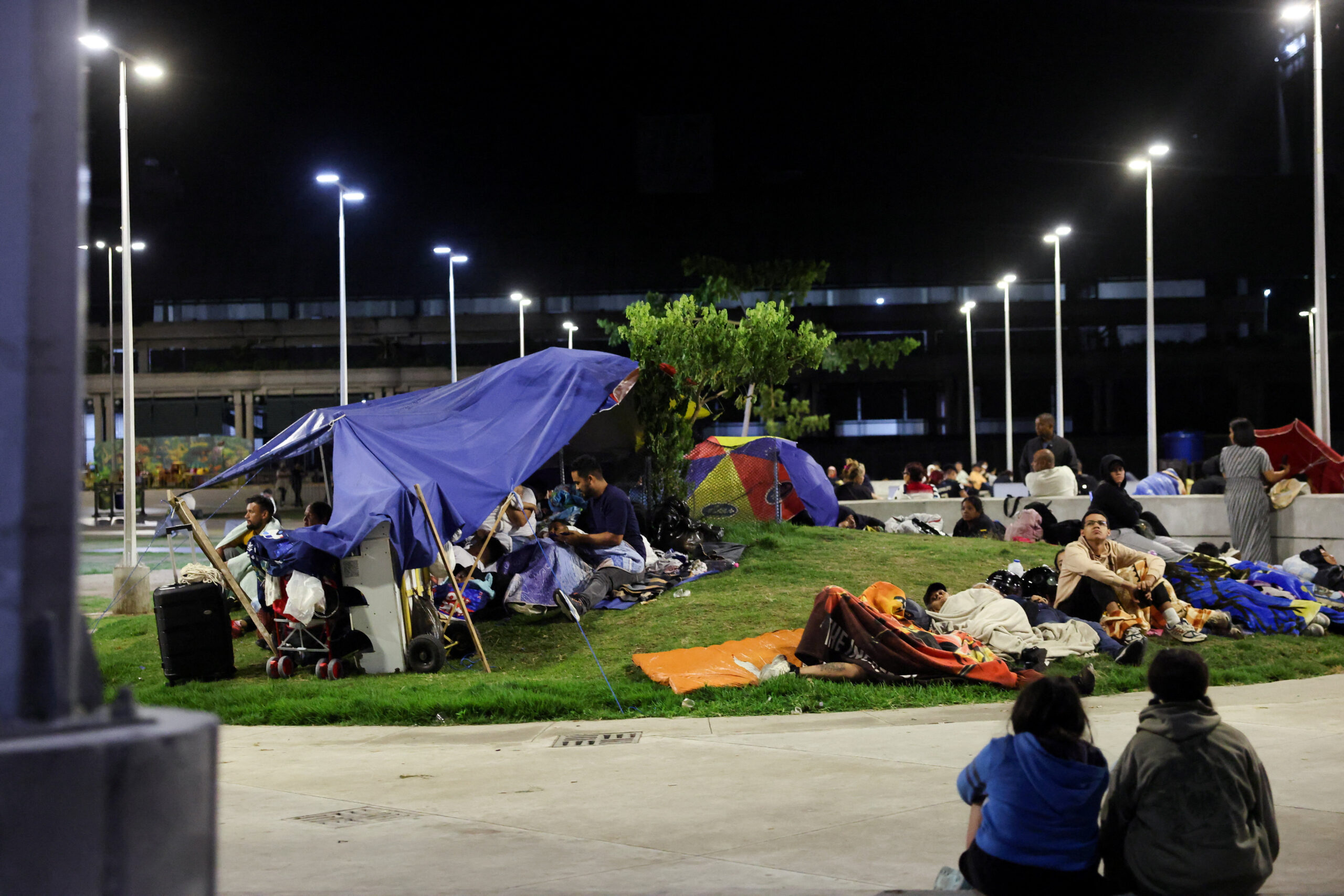 People rest in a square out of fear of going back into buildings, as emergency services (not pictured) work at the site of a collapsed building after earthquakes hit the country, in Caracas, Venezuela, June 25, 2026. REUTERS