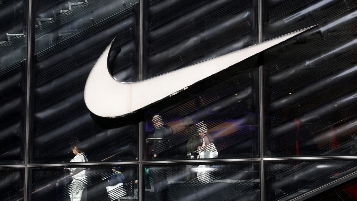 FILE PHOTO: People descend stairs inside a Nike store in New York City, U.S., April 2, 2025.