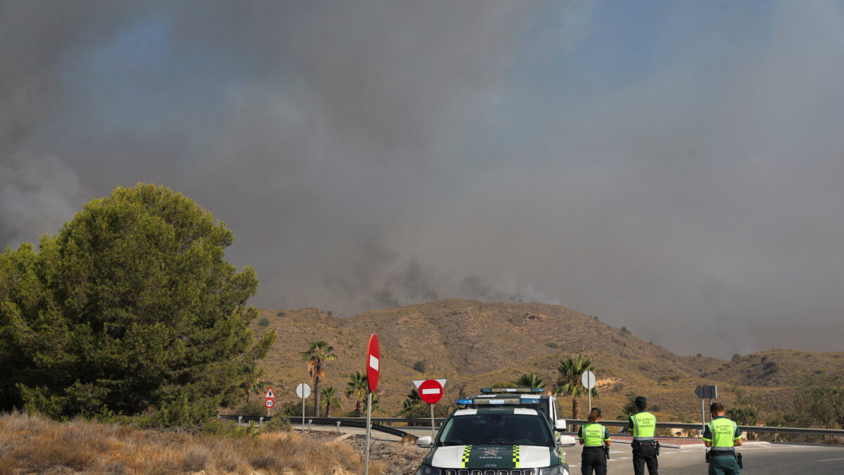 Members of the Spanish Civil Guard stand guard as smoke rises from a wildfire in Los Gallardos, Almeria, Spain, July 10, 2026. REUTERS/Loyola Perez de Villegas Muniz